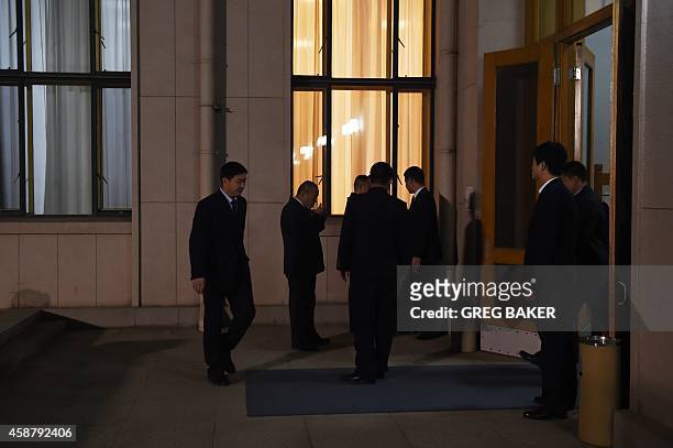 Chinese security officials stand outside a waiting room in the Zhongnanhai leadership compound, while US President Barack Obama has a private dinner...