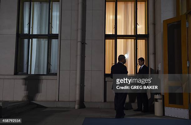 Chinese security officials stand outside a waiting room in the Zhongnanhai leadership compound, while US President Barack Obama has a private dinner...