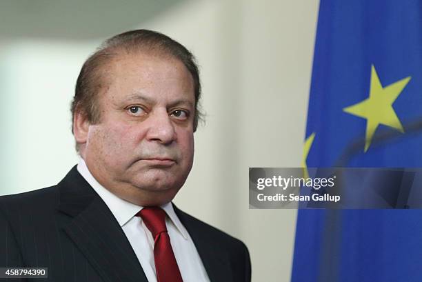 Pakistani Prime Minister Nawaz Sharif and German Chancellor Angela Merkel arrive to speak to the media following talks at the Chancellery on November...