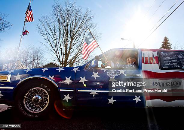 Larry Dearborn poses for a portrait with his 1997 Lincoln Town Car Limo that he drives around the state with his wife, Rita, to honor veterans of...