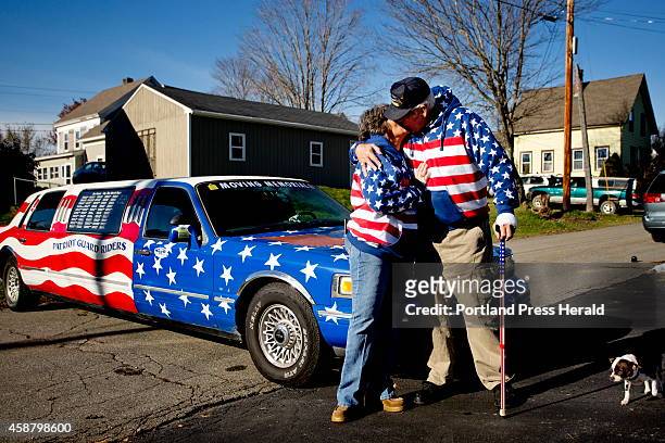 Rita Dearborn and her husband Larry share a kiss as they stand at the front of his 1997 Lincoln Town Car Limousine that they drive around the state...