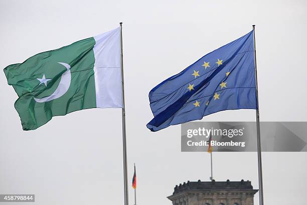 The national flag of Pakistan, left, and the European Union flag fly above the Chancellery in Berlin, Germany, on Tuesday, Nov. 11, 2014. Angela...