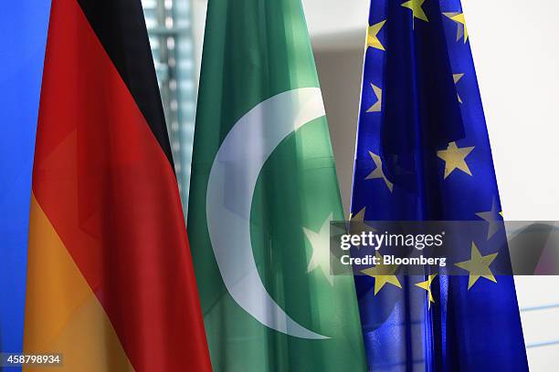 The national flags of Germany, left, and Pakistan, center, hang next to the European Union flag in the Chancellery in Berlin, Germany, on Tuesday,...