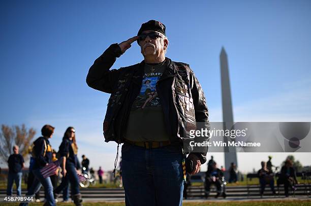 Vietnam war veteran Joe 'Dragon' Lozano, retired U.S. Army, salutes during the playing of ÒTapsÓ at a Veterans Day ceremony at the World War Two...