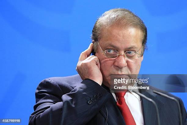 Nawaz Sharif, Pakistan's prime minister, listens via an ear piece during a news conference at the Chancellery in Berlin, Germany, on Tuesday, Nov....