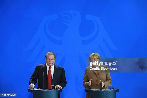 Nawaz Sharif, Pakistan's prime minister, left, looks on as Angela Merkel, Germany's chancellor, speaks during a news conference at the Chancellery in...
