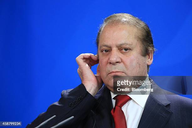 Nawaz Sharif, Pakistan's prime minister, listens via an earpiece during a news conference at the Chancellery in Berlin, Germany, on Tuesday, Nov. 11,...