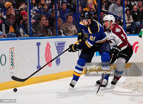 Patrik Berglund of the St. Louis Blues handles the puck as Nate Guenin of the Colorado Avalanche defends on November 1, 2014 at Scottrade Center in...