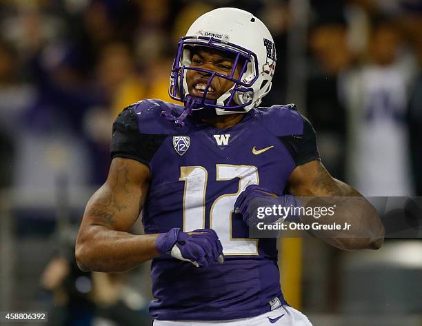 Running back Dwayne Washington of the Washington Huskies celebrates after scoring a touchdown against the UCLA Bruins on November 8, 2014 at Husky...