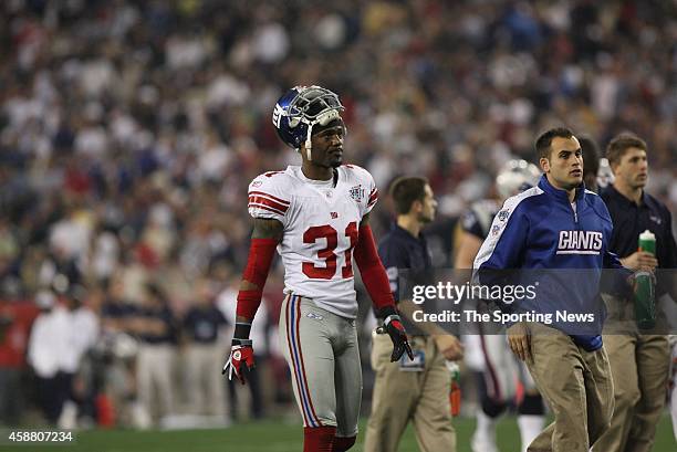 Aaron Ross of the New York Giants walks on to the field during Super Bowl XLII against the New England Patriots on February 3, 2008 at the University...