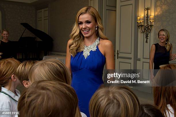 Katherine Jenkins poses for photographs with the Meath School choir during I CAN 'Million Lost Voices Appeal' gala concert and dinner at The Savoy...
