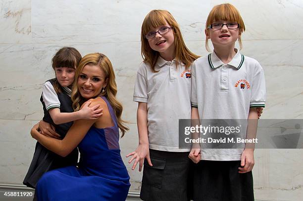 Katherine Jenkins poses for photographs with the Meath School choir during I CAN 'Million Lost Voices Appeal' gala concert and dinner at The Savoy...