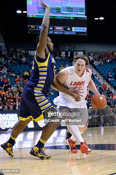 Cameron Bairstow of the New Mexico Lobos drives against Davante Gardner of the Marquette Golden Eagles during their game at the MGM Grand Garden...