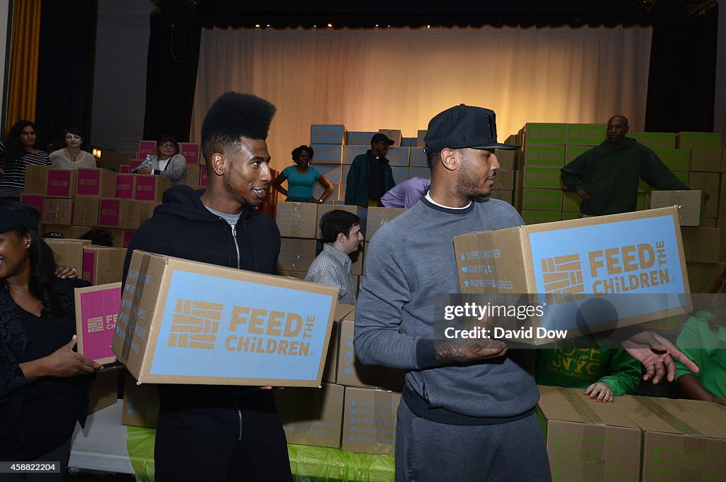 Carmelo Anothony Foundation and Feed the Children Organization hand out boexs of food in Harlem New York