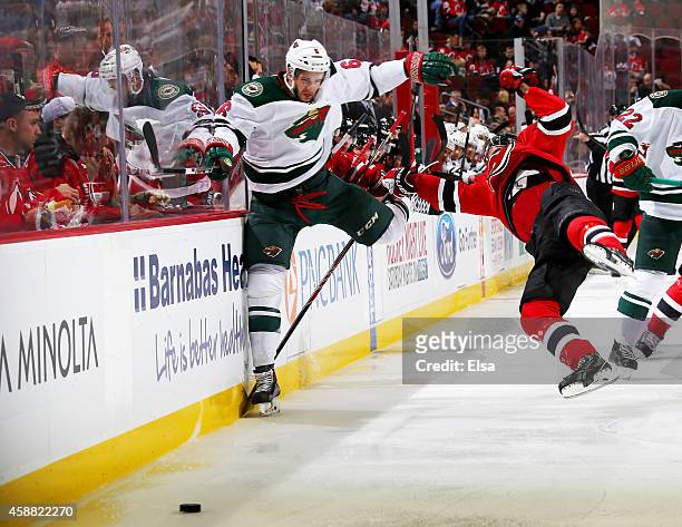 Marco Scandella of the Minnesota Wild and Jacob Josefson of the New Jersey Devils collide in the second period on November 11, 2014 at the Prudential...