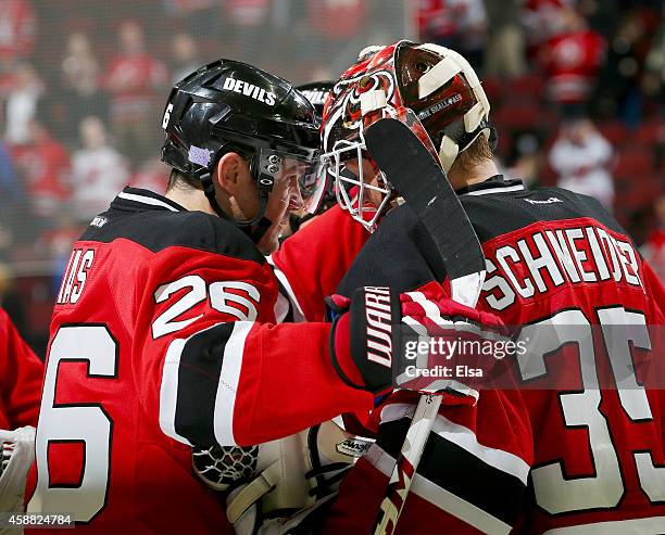 Patrik Elias of the New Jersey Devils celebrates the win with teammate Cory Schneider after the game against the Minnesota Wild on November 11, 2014...