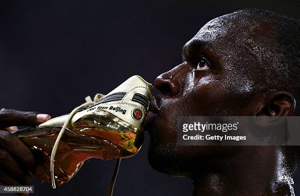 Usain Bolt of Jamaica kisses his shoes after winning the Men's 100m Final at the National Stadium on Day 8 of the Beijing 2008 Olympic Games on...