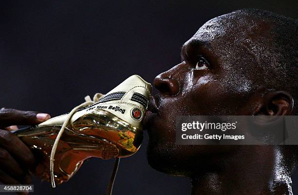 Usain Bolt of Jamaica kisses his shoes after winning the Men's 100m Final at the National Stadium on Day 8 of the Beijing 2008 Olympic Games on...