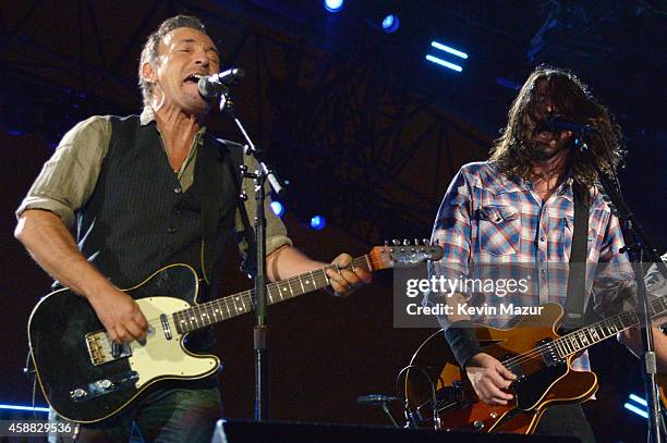 Bruce Springsteen and Dave Grohl perform onstage during "The Concert For Valor" at The National Mall on November 11, 2014 in Washington, DC.