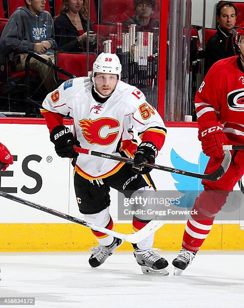 Max Reinhart of the Calgary Flames skates for a loose puck on the ice during their NHL game against the Carolina Hurricanes at PNC Arena on November...