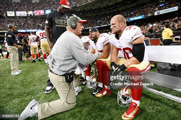 Linebackers Coach Jim Leavitt of the San Francisco 49ers talks with Chris Borland during the game against the New Orleans Saints at the Mercedes-Benz...