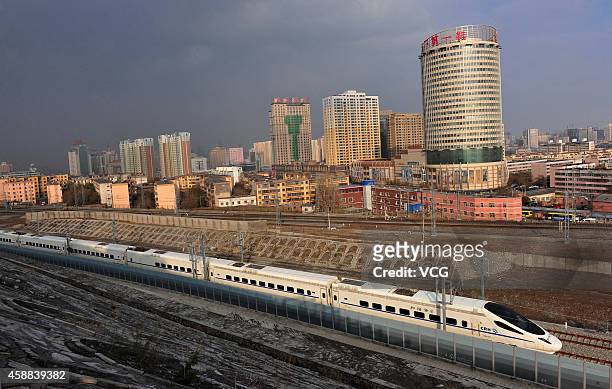 High-speed train runs across Urumqi city during its test run on November 11, 2014 in Urumqi, Xinjiang Uyghur Autonomous Region of China. The railway,...