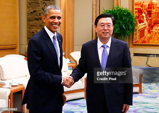 President Barack Obama shakes hands with Chairman of the Standing Committee of the National People's Congress Zhang Dejiang during a meeting at the...