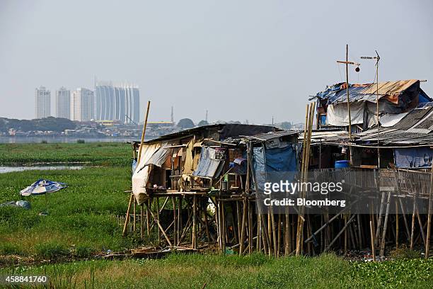 Shanty houses stand perched on stilts near the Pluit Dam area of North Jakarta, Indonesia, on Wednesday, Nov. 5, 2014. Jakarta, a former Dutch...
