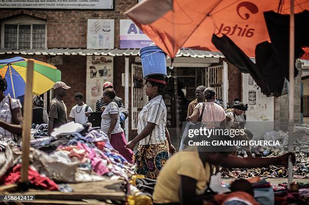 People shop at an open air market on Patrice Lumumba road in Lusaka on November 12 a day after the burial of the late Zambian president. AFP...