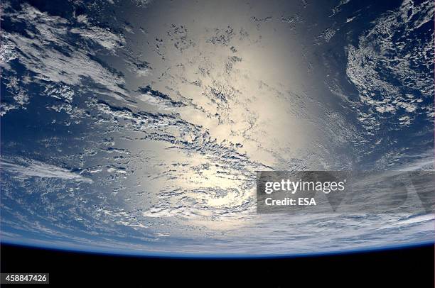 In this handout photo provided by the European Space Agency on July 17 German ESA astronaut Alexander Gerst took this image of the Earth reflecting...