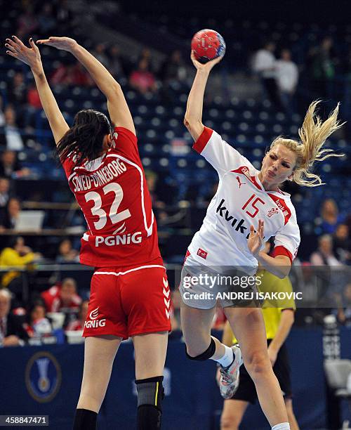 Poland's Karolina Szwed challenges Denmark's Pernille Holst Holmsgaard during the 2013 Women's Handball World Championship match for third place...