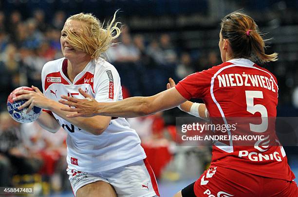 Denmark's Pernille Holst Holmsgaard challenges Poland's Iwona Niedzwiedz during the 2013 Women's Handball World Championship match for third place...