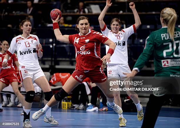 Polands Karolina Kudlacz advances to score against Denmarks goalkeeper Rikke Vestergaard Poulsen during the 2013 Women's Handball World Championship...