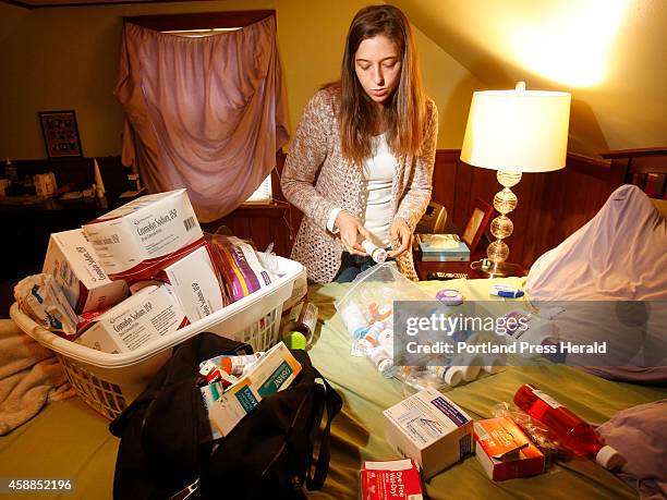 Crystal Goodwin shows the numerous medications on Thursday, October 23, 2014 that she must take in order to combat mast cell activation syndrome.