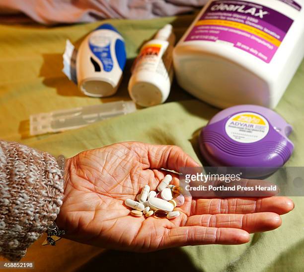 Crystal Goodwin holds the array of pills that she takes every night in order to stave off severe allergic reactions that are occur because she has...