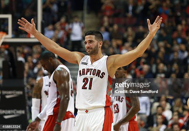 Greivis Vasquez of the Toronto Raptors raises his arms to prompt the crowd to make noise as his team faces the Oklahoma City Thunder during their...