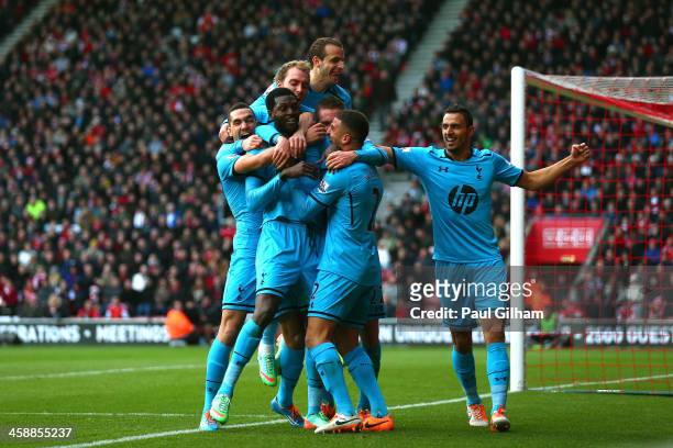 Emanuel Adebayor of Spurs celebrates with teammates after scoring his team's third goal during the Barclays Premier League match between Southampton...