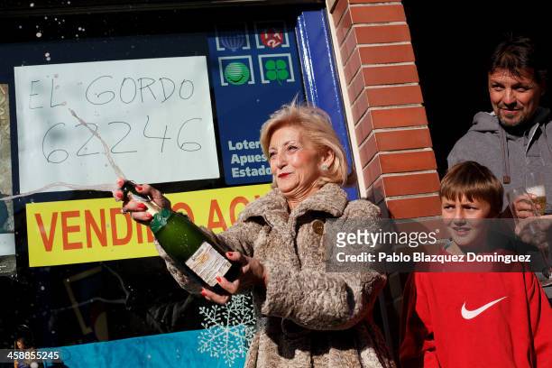 Lottery administration shop owner Maria Luisa celebrates with Juan Luis Moreno whose mother won a top prize ticket number in Spain's Christmas...