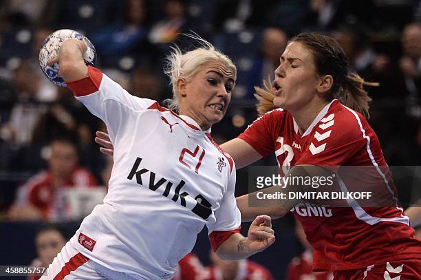Denmarks Kristina Kristiansen vies with Polands Alina Wojtas during the Women's Handball World Championship match for third place between Denmark and...