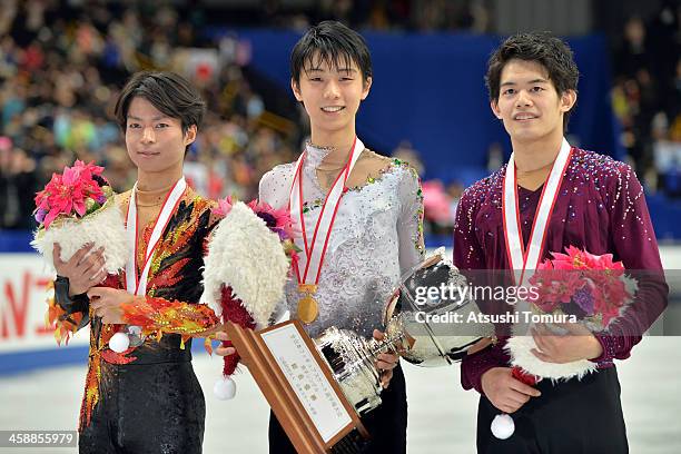Tatsuki Machida of Japan, Yuzuru Hanyu of Japan and Takahiko Kozuka of Japan pose with their medals in the men's single victory ceremony during All...