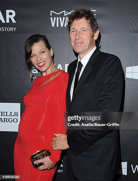 Actress Milla Jovovich and director Paul W.S. Anderson arrive at the 2014 amfAR LA Inspiration Gala at Milk Studios on October 29, 2014 in Hollywood,...