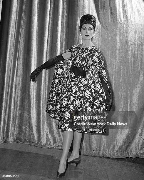 Fashion Show at Waldorf - Chemise slip with poncho swathes Jackie Rogers, who's modeling a black-and-white number from Traina-Norell, Anthony Traina...