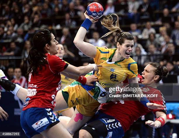 Brazils Deonise Cavaleiro challenges Serbia's Sanja Damnjanovic and Dragana Cvijic during the 2013 Women's Handball World Championship final match...