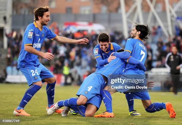 Lisandro Lopez of Getafe CF celebrates with Angel Lafita and Pedro Mosquera after scoring Getafe's 2nd goal during the La Liga match between Getafe...