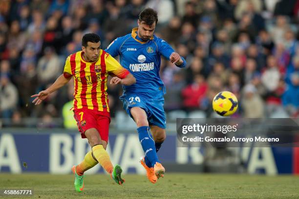 Pedro Rodriguez Ledesma of FC Barcelona scores their opening goal against Juan Valera Espin of Getafe CF during the La Liga match between Getafe CF...