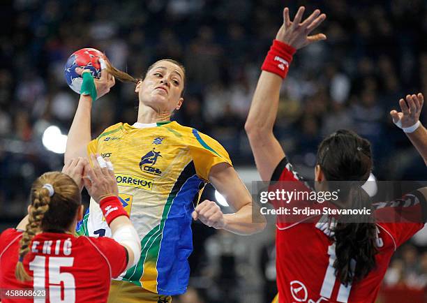 Eduarda Amorim of Brazil in action against Jelena Eric and Sanja Damnjanovic of Serbia during the World Women's Handball Championship 2013 Final...