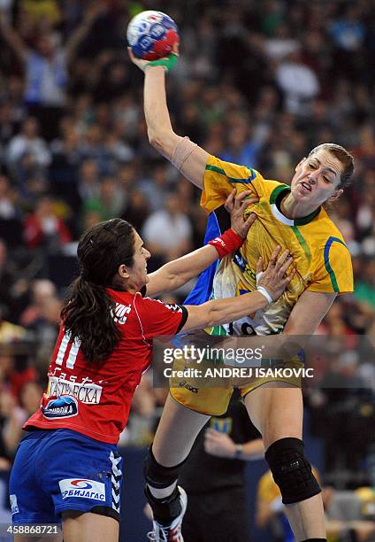 Brazil's Eduarda Amorim challenges Serbia's Sanja Damnjanovic during the 2013 Women's Handball World Championship final match between Brazil and...