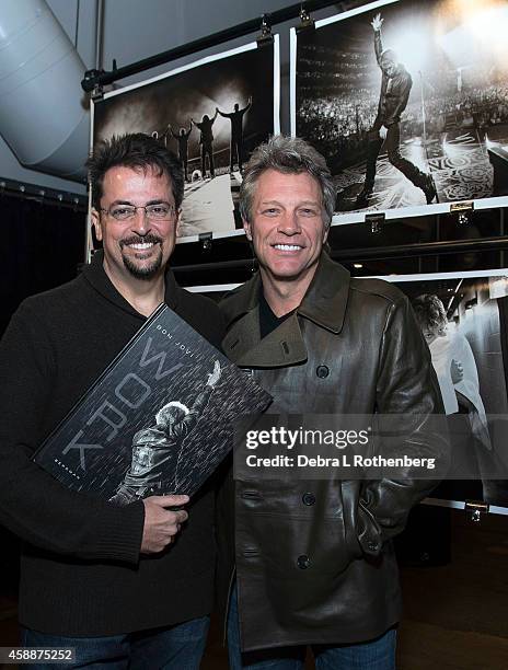 Author/Photographer David Bergman and musician Jon Bon Jovi attend the book signing for "Work" at Altman Building on November 12, 2014 in New York...
