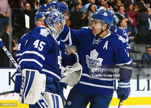 Jonathan Bernier and Stephane Robidas of the Toronto Maple Leafs celebrate the win against the Boston Bruins during NHL game action November 12, 2014...