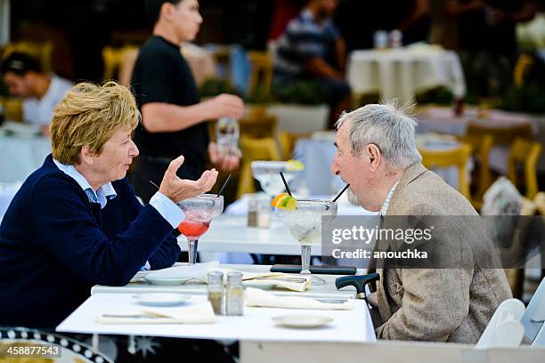 senior couple drinking cocktails on ocean drive, miami beach - ocean drive drink stock pictures, royalty-free photos & images